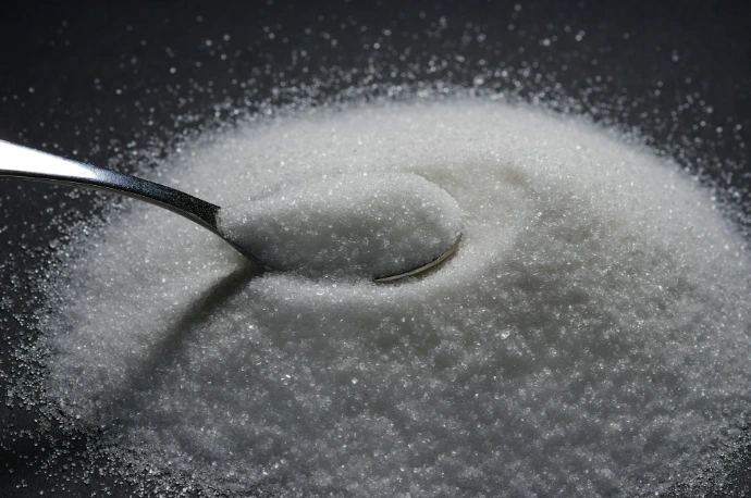 a spoon full of sugar on top of a table